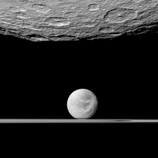 Looking past Rhea to Dione and Saturn's rings