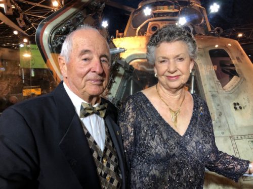 Bill and Valerie Anders, standing in front of the Apollo 8 capsule