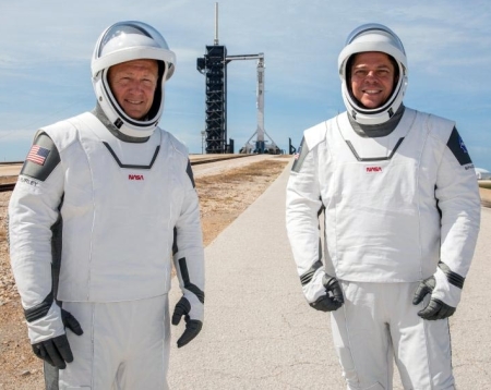 Douglas Hurley and Robert Behnken, with Falcon 9 in background