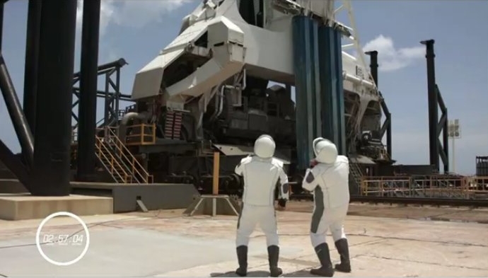 Doug Hurley and Bob Behnken look up at Falcon 9