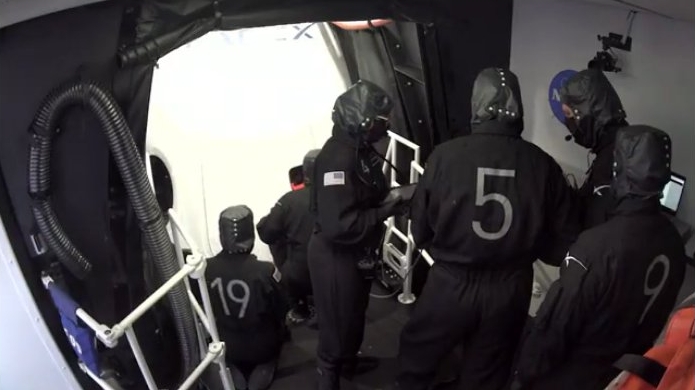 The ground crew doing the leak check after closing the hatch