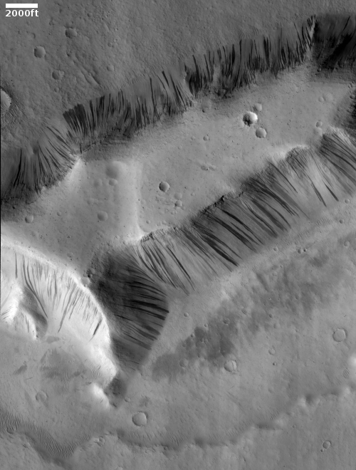 A moated mesa in Kasai Valles, with many slope streaks