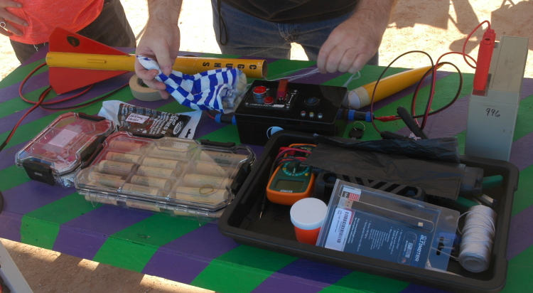 Morris showing the students the final rocket assembly