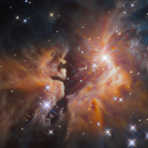 Interstellar clouds backlit by nearby massive star