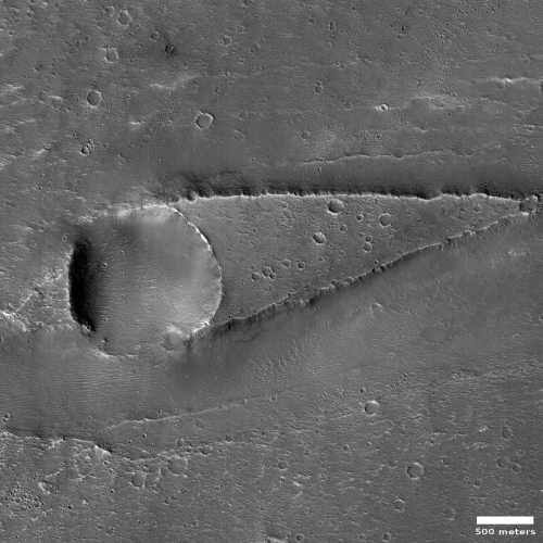 Martian crater and mesa sculpted by ancient flow