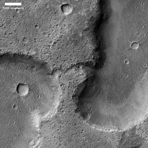 Drainage channel between two Martian hollows