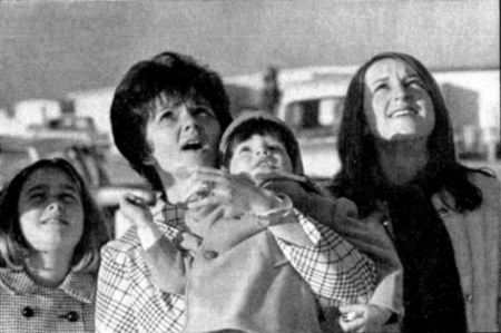 Marilyn Lovell, holding son Jeffrey, watches the Saturn 5 lift-off with daughters Susan, right, and Barbara, left