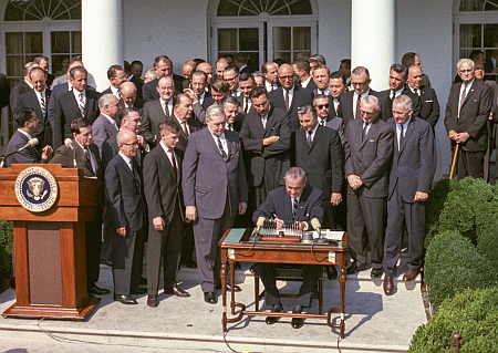 Johnson signing the Equal Opportunity Act in 1964